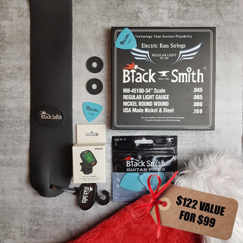 BlackSmith black leather strap, black strap locks, 45/100 bass strings, BlackSmith blue picks, Aroma digital chromatic tuner and Christmas stocking. Tag reads "$122 value for $99"