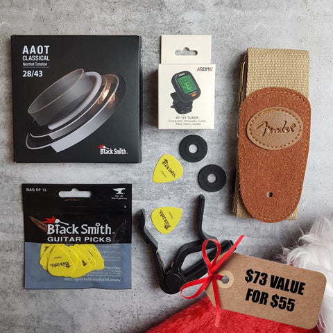 Blacksmith normal tension nylon strings for classical guitar, BlackSmith yellow picks, Aroma digital chromatic tuner, black capo, generic beige guitar strap and Christmas stocking. Tag reads "$73 value for $55"
