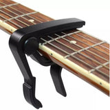 Black capo on acoustic guitar neck