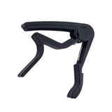 Black guitar capo on white background