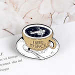 "I need my space" pin with book as background