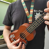 Man playing ukulele while wearing lanyard style strap