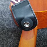 Strap and strap lock attached to chrome strap button on ukulele